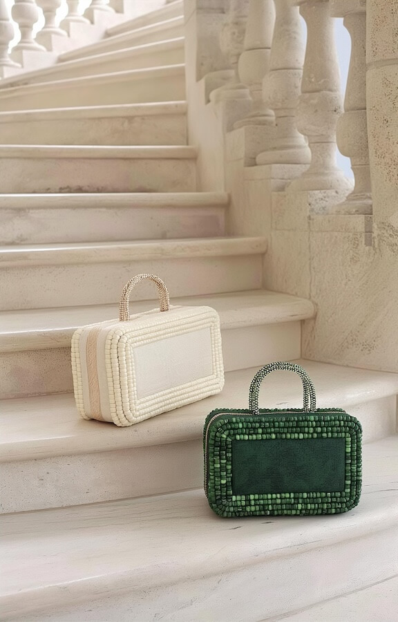 two-white-and-green-box-shaped-handbags-on-the-stairs