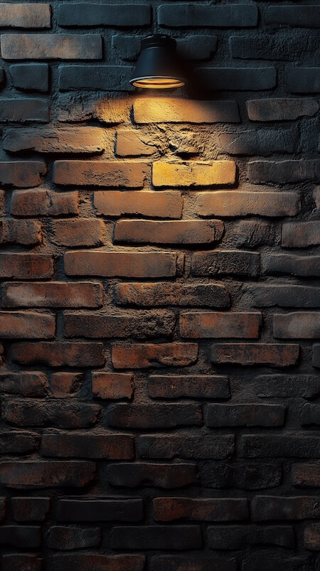 dark-brick-wall-with-one-warm-light-illuminating-the-scene